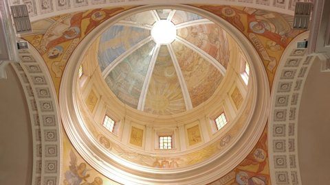 Ortona / Italy - 11 26 2018: Tilt shot of the interior of the Basilica of St. Thomas the Apostle, also Ortona Cathedral. View of the frescoed dome and the central nave.