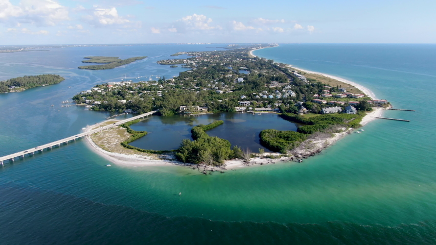 Aerial view of Longboat Key town and beaches in Manatee and Sarasota counties along the central west coast of the U.S. state of Florida, Royalty-Free Stock Footage #1039557623