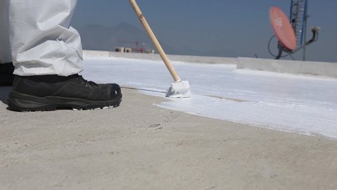Roof coating application process with a broom