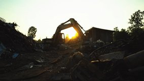 silhouette Backhoe use electromagnets crane keeping meta at recycle factory with sunlight  - Powered by Shutterstock - Get 15% off with code: PIKWIZARD15