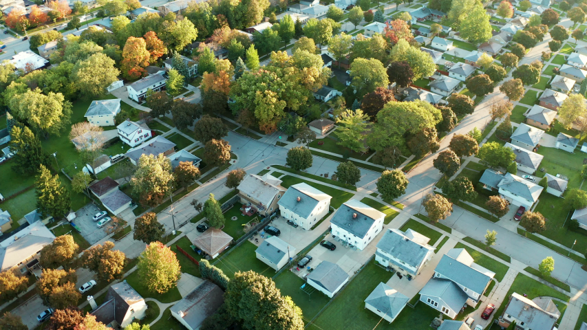 Aerial view of residential houses at autumn (october). American neighborhood, suburb. Real estate, drone shots, sunset, sunny morning,  sunlight, from above Royalty-Free Stock Footage #1039567358