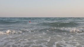Slow motion sea surface with red buoy 1080p video