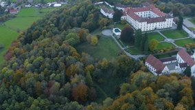 Aerial view of the palace, castle Schloss Zeil im Allgäu in Germany on a late afternoon in autumn.Pan to the left above the castle.