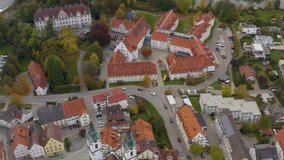 Aerial view of the city Bad Waldsee in Germany on a sunny late afternoon in autumn. Pan to the right above the church.