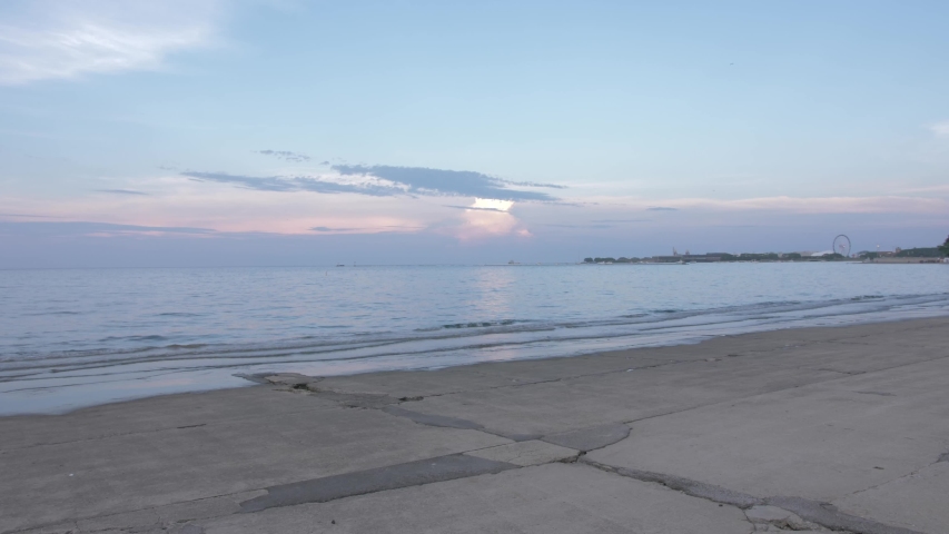 Pan shot from Michigan Lake to city skyline from Lakefront Trail at dusk, Chicago, Illinois, United States of America, North America