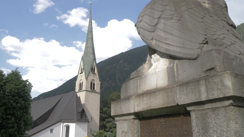 War memorial statue and church, Mayrhofen, Tyrol, Austrian Alps, Austria, Europe
