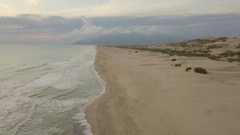 Beautiful beach on the sea coast with salt water and sand on a summer day at sunset. Aerial view. Natural background. Exotic landscape. Patara Beach in Turkey
