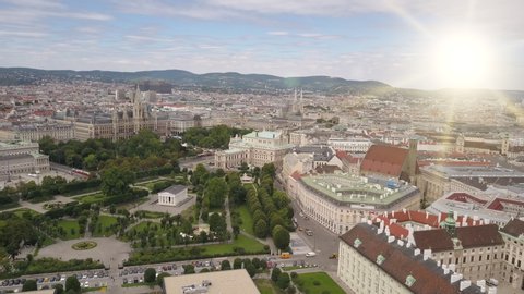 Aerial view of Vienna in the rays of the setting sun. Heldenplatz, Rathaus, Volksgarden and university of Vienna skyline aerial shot. Cathedrals and cityscape City of Vienna, Austria.
