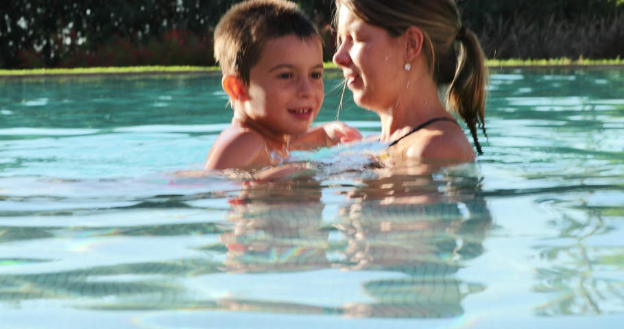Mom and child together at the swimming pool water | Shutterstock HD Video #1039605653