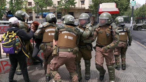 Santiago de Chile
Chile
19/10/2019
""Carabineros"" Police arresting a protester in Plaza Italia square during riots. The army went out to the streets to dissolve the "Evade" movement demonstrations