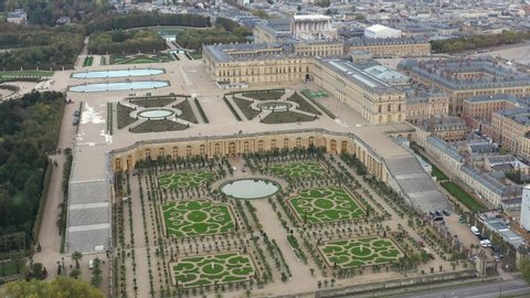French castle, Palace of Versailles (Chateau de Versailles), drone aerial view with landscaped gardens & orangery