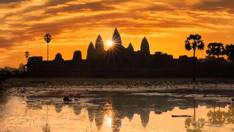 Angkor Wat, Siem Reap/Cambodia - February 2 2018: Sunrise at Angkor Wat Cambodia, with the reflecting pond in the foreground and the temple silhouetted with the sun rising by the main temple.