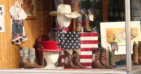 Nashville, Tennessee - June 20, 2019: Cowboy boots and hats on display in a Western wear store window in Nashville Tennessee USA