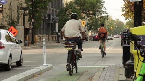 Winnipeg / Canada - September 15 2017: Cyclists in Cycle Lane Go Through Traffic Light in Winnipeg, Canada