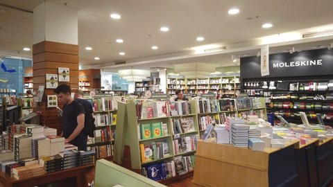 Sydney, Australia - Sept 30 2019: interior quiet kinokuniya brick and motar big retail book store with aisle modern wood book shelf display. reader enjoy browsing flip through pages free. 