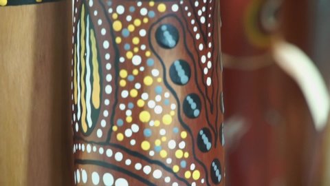 Slow pan and closeup of the beautiful artwork of an Australian Aboriginal Digeridoo