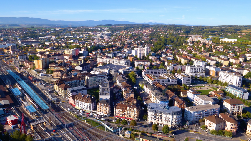 Helicopter aerial over Renens city center and train station. Lausanne area, Switzerland