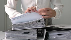 Business woman or professional execuitve’s hands flipping through documents inside arch file in an office. Searching for information. Business or work place concept. - Powered by Shutterstock - Get 15% off with code: PIKWIZARD15