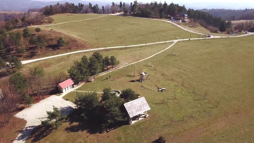 Aerial: Wonderful countryside nature picnic place with kids playground. Beautiful Slovenian etno village with tourist farms.