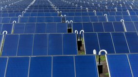 Solar thermal collectors. Solar panels farm field of green renewable energy. Close up drone video of cell panels Rotates to right. 4k footage