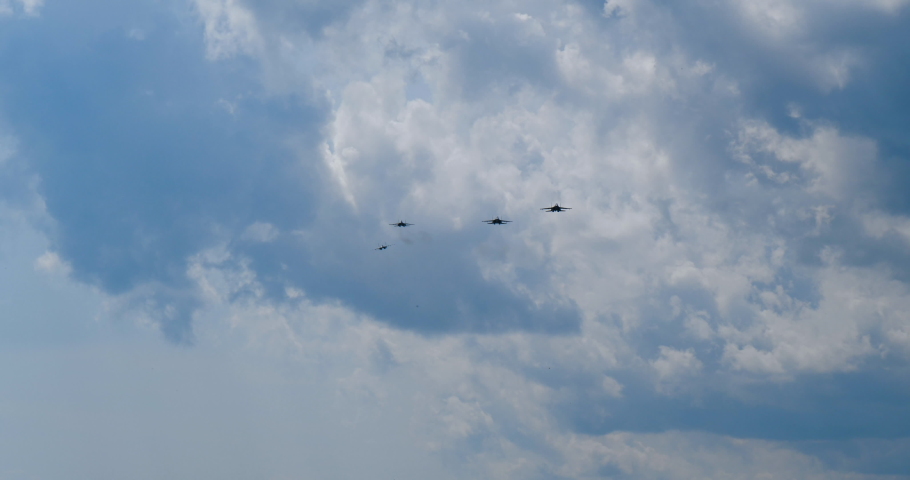 Four jets su-35 approach in slow motion to attack and maneuver while flying close up. Military su-35 field is ready for approach of warring parties. Jet fly su35.