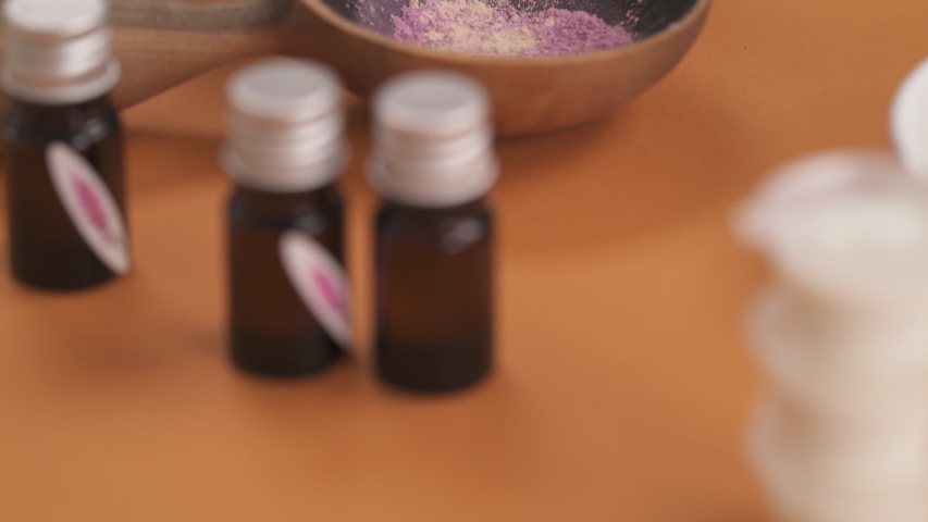 Natural craft cosmetics. Close-up of dried herbs powder and aromatic essential oils. Bottom top shot. Isolated, selective focus