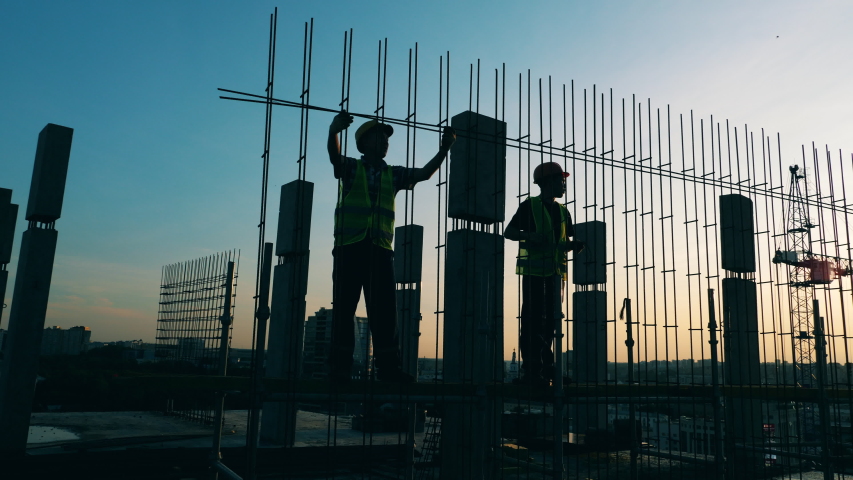 Building workers are constructing a metal framework Royalty-Free Stock Footage #1039651076