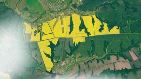 Cultivated field aerial satellite view, yellow rapeseed agriculture land animation.  Contains public domain image by Nasa