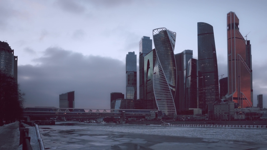 Time Lapse. Financial district of Moscow. Winter morning, dawn. River is covered with ice, modern skyscrapers in the background. All Logo are blurred and deleted in post-production. Ultra HD footage