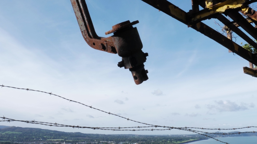 Gorgeous tilting shot of the beach in Bray Town, Ireland. Shot from the perspective of a bridge up on a hill.