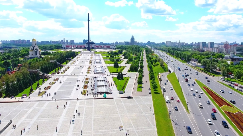 Aerial view of the Victory Park on Poklonnaya Hill, surrounded by green trees and road car. Taken by drone at Moscow