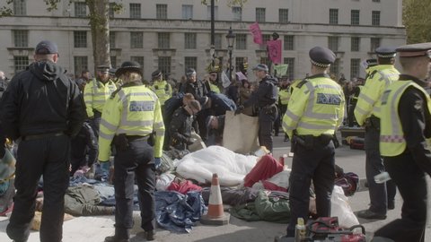 London , London / United Kingdom (UK) - 10 09 2019: Extinction Rebellion demonstrators glued to others next to the Women of World War Two memorial on Whitehall road in Westminster.
