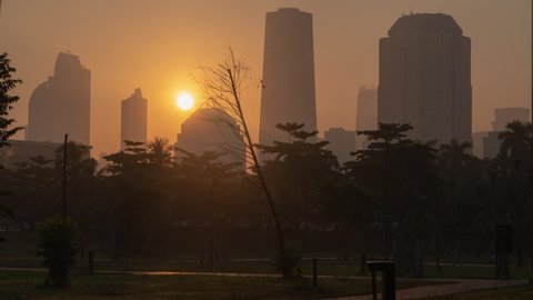 Jakarta, Indonesia - CIRCA 2019: Jakarta Metropolitan Mega City Indonesia Asia Skyline Buildings SkyScrapers Time Lapse Sunrise