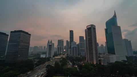 Jakarta, Indonesia - CIRCA 2019: Jakarta Metropolitan Mega City Indonesia Asia Skyline Buildings SkyScrapers Time Lapse Day to Night