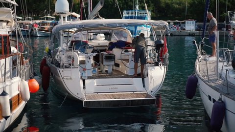 Kas, Turkey, October 2019: Kas, Turkey, October 2019: A yacht goes to sea from the pier in the city of Kas in the Mediterranean Sea on a sunny day