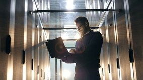 IT specialist works in data center, checking equipment. - Powered by Shutterstock - Get 15% off with code: PIKWIZARD15