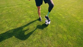 A man with a bionic leg is kicking the ball around - Powered by Shutterstock - Get 15% off with code: PIKWIZARD15