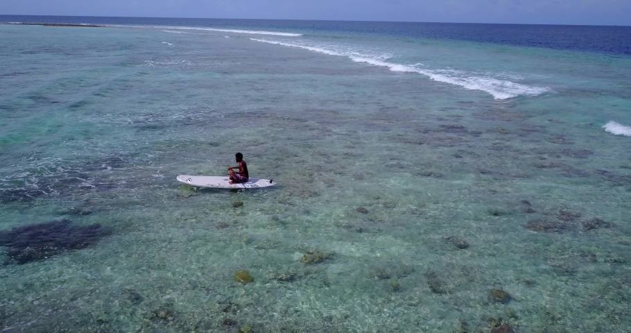 Paddleboarding in tropical waters. African man on the paddleboard African coast