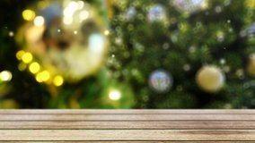 4K. snow falls on wooden table in front of blurry christmas tree decorate with ornament ball and bokeh lighting at background with copy space - Powered by Shutterstock - Get 15% off with code: PIKWIZARD15