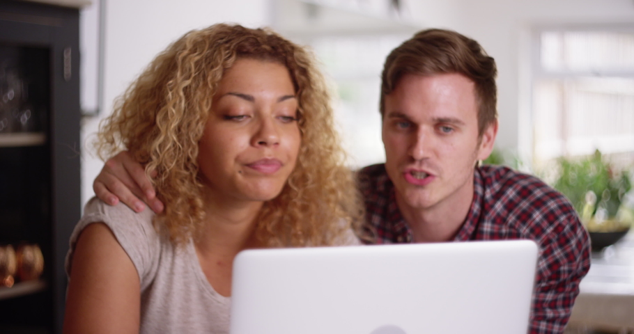 4K Cute couple messing around, man distracting his girlfriend while she tries to work on laptop. Slow motion.