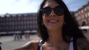 SLOW MOTION: Beautiful smiling young woman portrait spinning around with boyfriend outdoors with Plaza Mayor in the background. Lifestyle video. Madrid, Spain.
