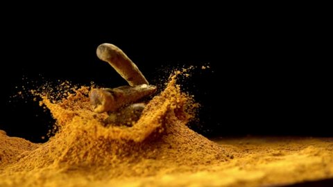 Turmeric, curcuma longa, Root falling on curcuma Powder, Indian Spice, Slow Motion