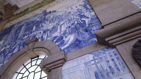 Porto / Portugal - 05 27 2019: The interior of Sao Bento Train Station in Porto is decorated in the country's iconic azulejo ceramic tile art.
