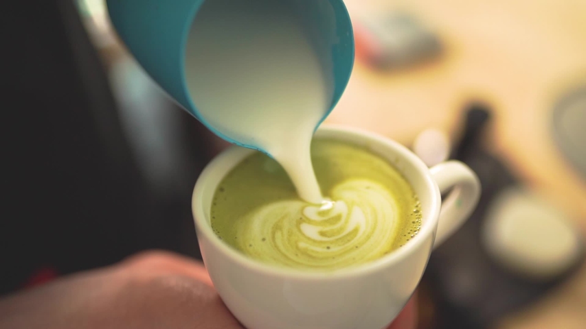 Slow motion of barista pouring milk over creating Matcha latte art | Shutterstock HD Video #1039740773