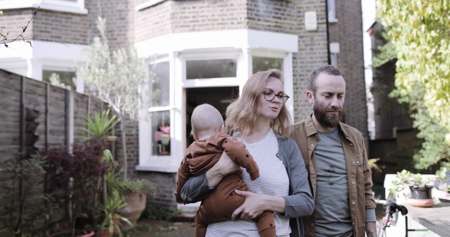 Family standing walking into garden