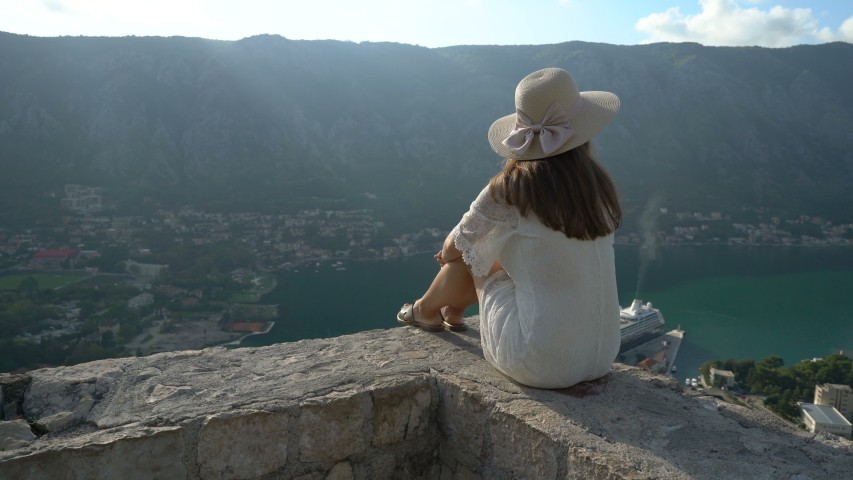 A girl looks from the heights to the Boka Bay of Kotor