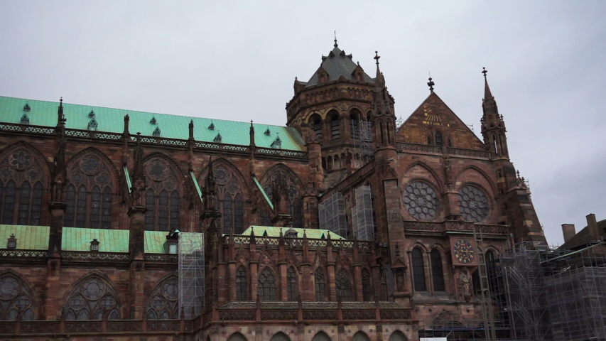 Panoramic view in slow motion of the Strasbourg Cathedral church (Cathédrale Notre-Dame). Old town gothic architecture, catholic religion, travel landmark.