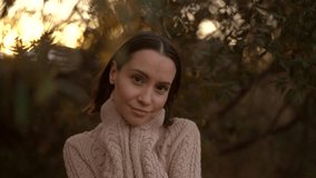 Outdoor slow motion video of young beautiful lady in fall. Knitted sweater. Warm Autumn.