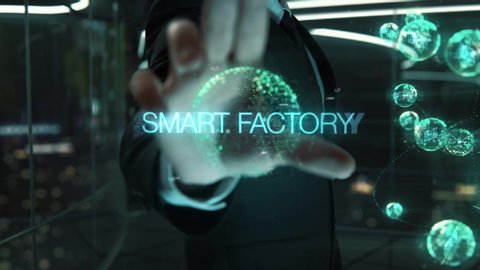 Businessman with Smart Factory hologram concept