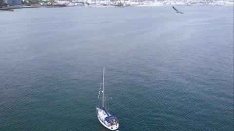 Yachting recreaton adventure hobby concept - Aerial top down view sailboat vessel in ocean 